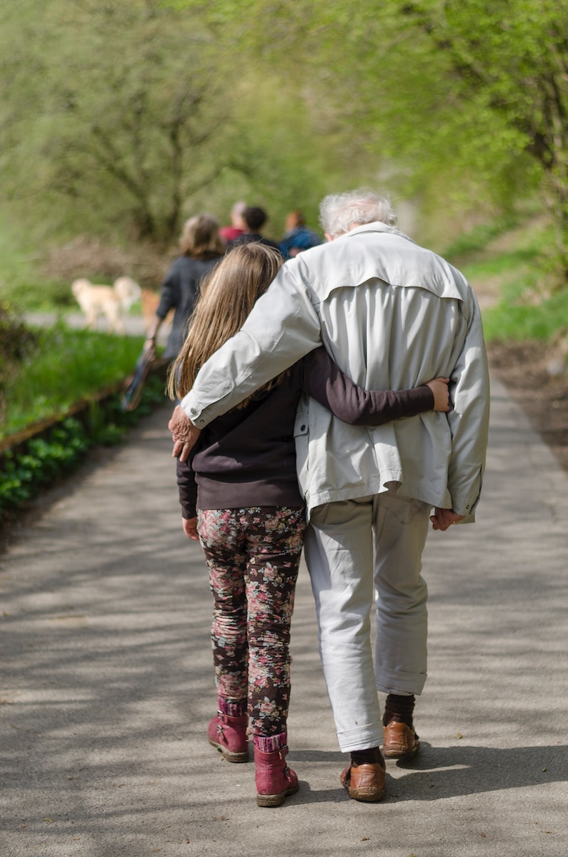 Man walking at a park with girl